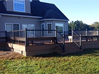 <b>Composite deck with black aluminum railing, brown composite fascia and brown lattice</b>